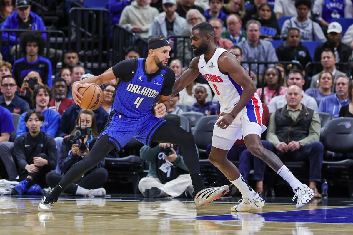 Jan 25, 2025; Orlando, Florida, USA; Orlando Magic guard Jalen Suggs (4) drives to the basket against Detroit Pistons forward Tim Hardaway Jr. (8) during the first quarter at Kia Center. Mandatory Credit: Mike Watters-Imagn Images