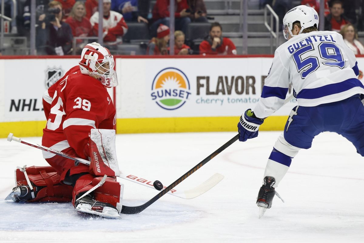 Jan 25, 2025; Detroit, Michigan, USA;  Detroit Red Wings goaltender Cam Talbot (39) makes a save on Tampa Bay Lightning center Jake Guentzel (59) in the first period at Little Caesars Arena. Mandatory Credit: Rick Osentoski-Imagn Images