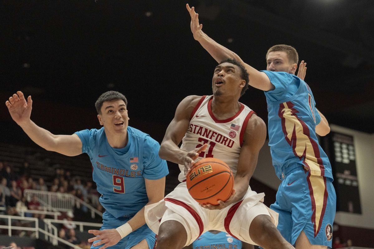 Jan 25, 2025; Stanford, California, USA;  Stanford Cardinal guard Jaylen Blakes (21) shoots the ball against Florida State Seminoles guard Anastasios Rozakeas (9) and forward Christian Nitu (11) during the first half at Maples Pavilion. Mandatory Credit: Stan Szeto-Imagn Images
