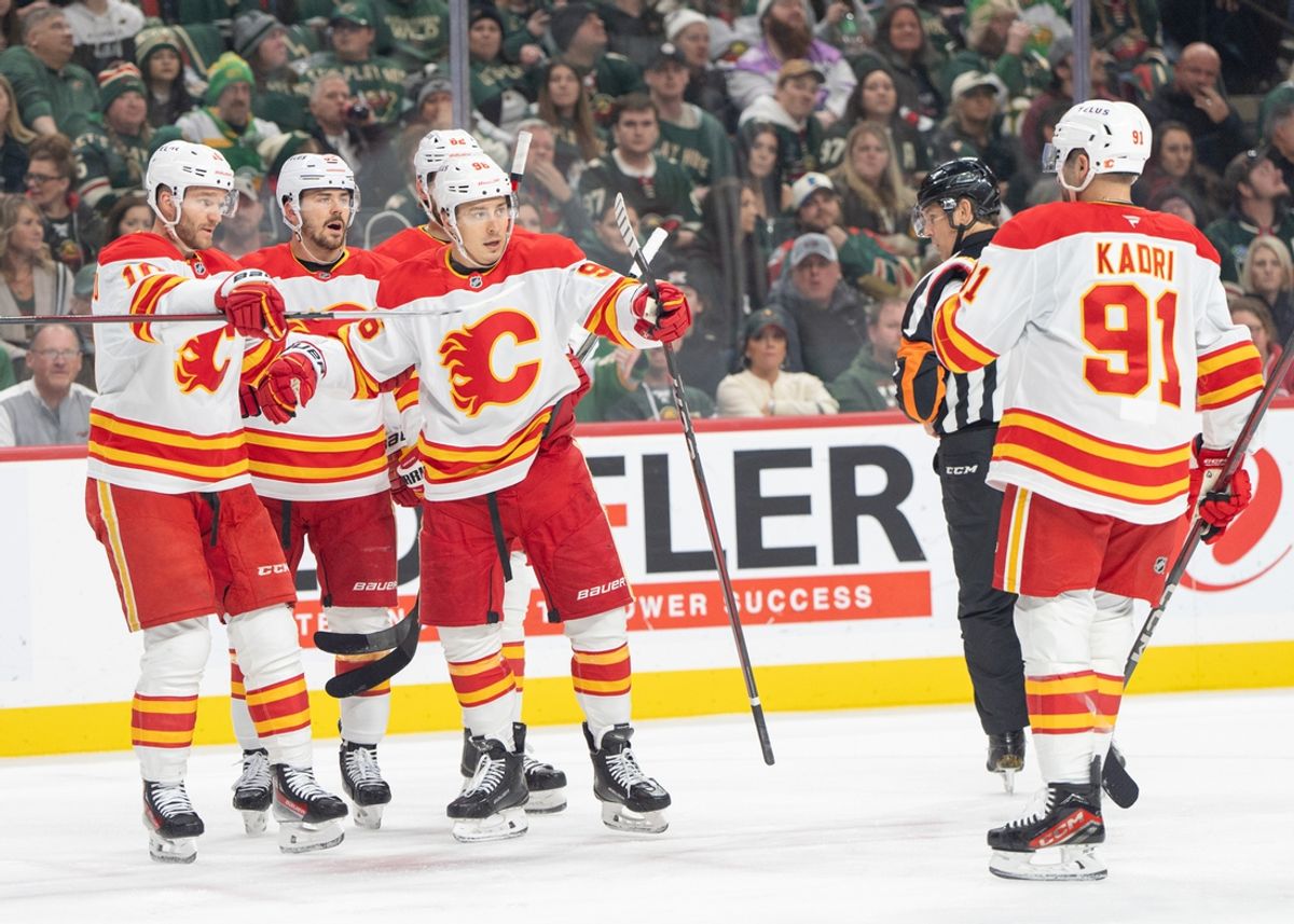Jan 25, 2025; Saint Paul, Minnesota, USA; Calgary Flames left wing Andrei Kuzmenko (96) celebrates with teammates after scoring against the Minnesota Wild in the first period at Xcel Energy Center. Mandatory Credit: Matt Blewett-Imagn Images
