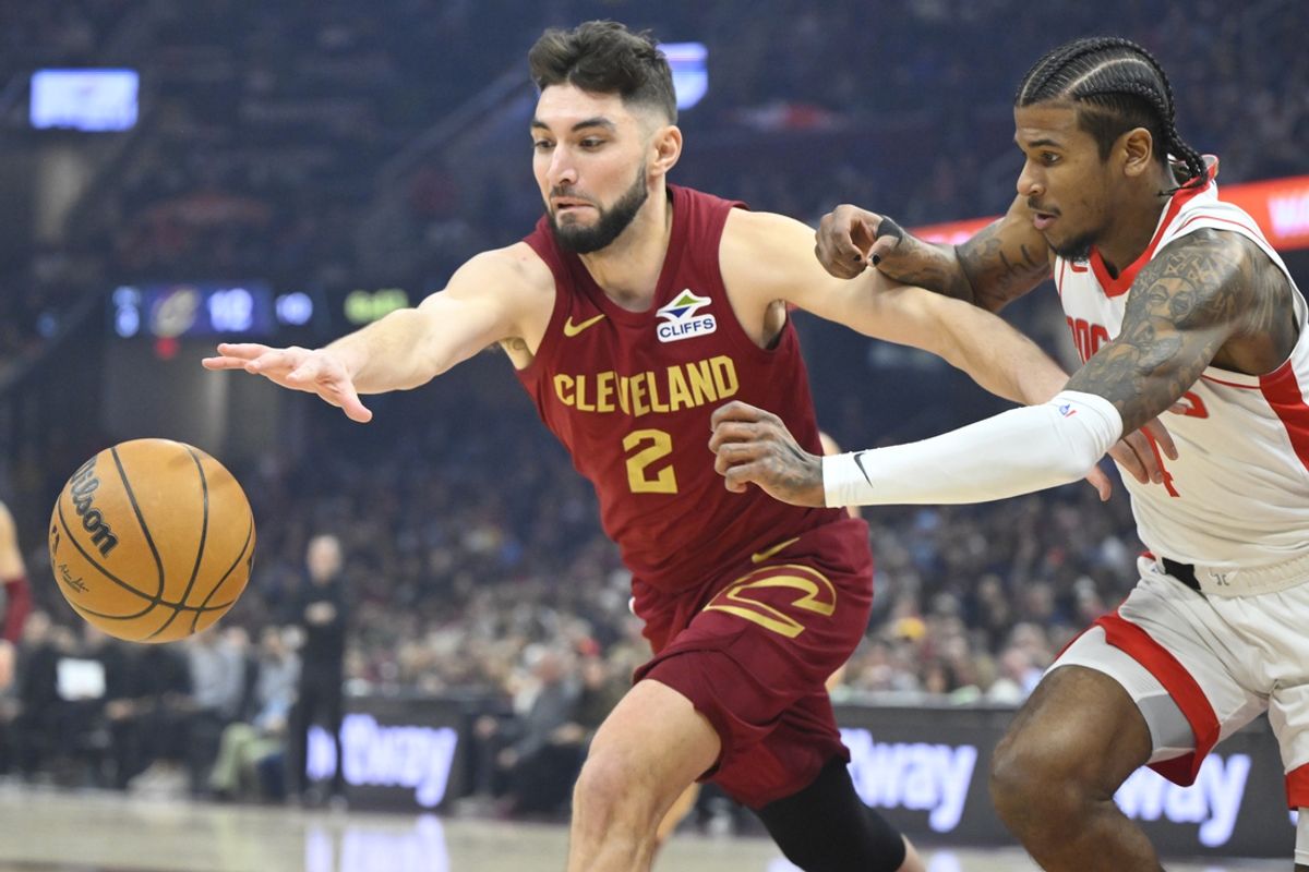 Jan 25, 2025; Cleveland, Ohio, USA; Cleveland Cavaliers guard Ty Jerome (2) and Houston Rockets guard Jalen Green (4) reach for a loose ball in the first quarter at Rocket Mortgage FieldHouse. Mandatory Credit: David Richard-Imagn Images