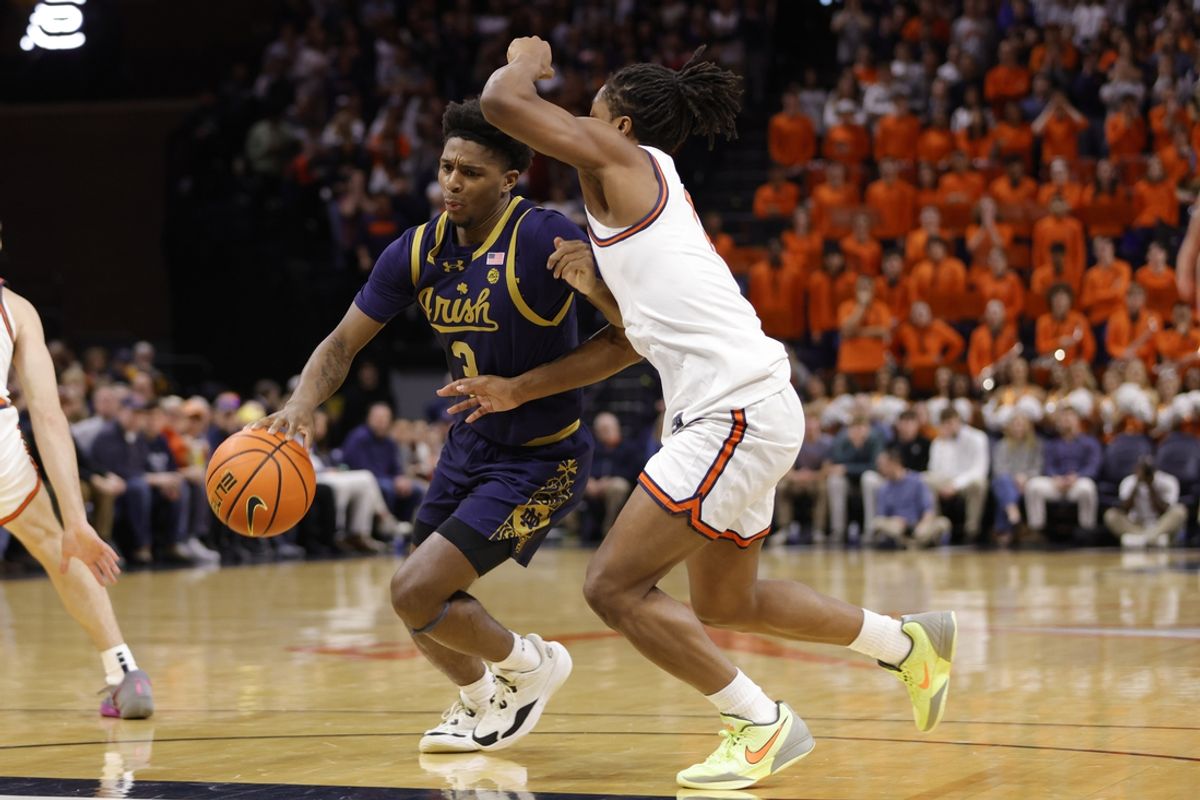 Jan 25, 2025; Charlottesville, Virginia, USA; Notre Dame Fighting Irish guard Markus Burton (3) controls the ball as Virginia Cavaliers guard Dai Dai Ames (7) defends during the first half at John Paul Jones Arena. Mandatory Credit: Amber Searls-Imagn Images