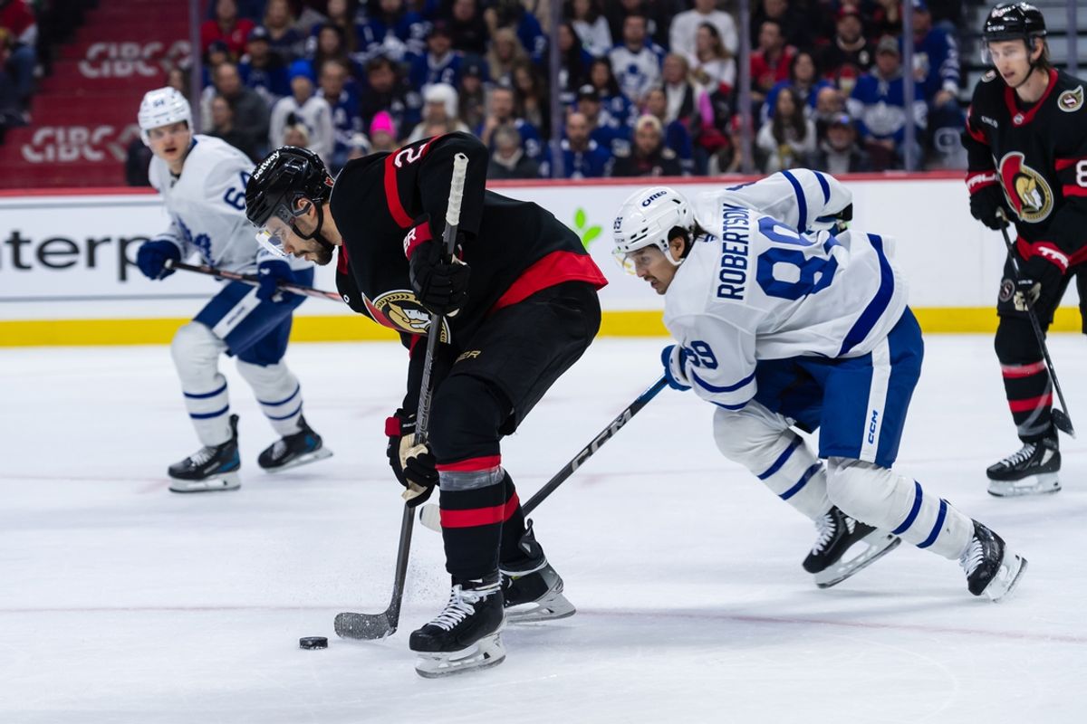 Jan 25, 2025; Ottawa, Ontario, CAN; Ottawa Senators defenseman Artem Zub (2) moves the puck away from Toronto Maple Leafs left wing Nicholas Robertson (89) in the second period at the Canadian Tire Centre. Mandatory Credit: Marc DesRosiers-Imagn Images