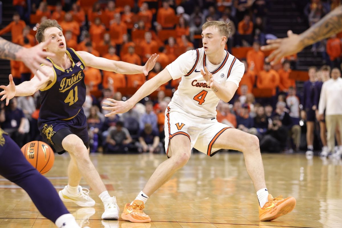 Jan 25, 2025; Charlottesville, Virginia, USA; Virginia Cavaliers guard Andrew Rohde (4) passes the ball in front of Notre Dame Fighting Irish guard Matt Allocco (41) during the second half at John Paul Jones Arena. Mandatory Credit: Amber Searls-Imagn Images