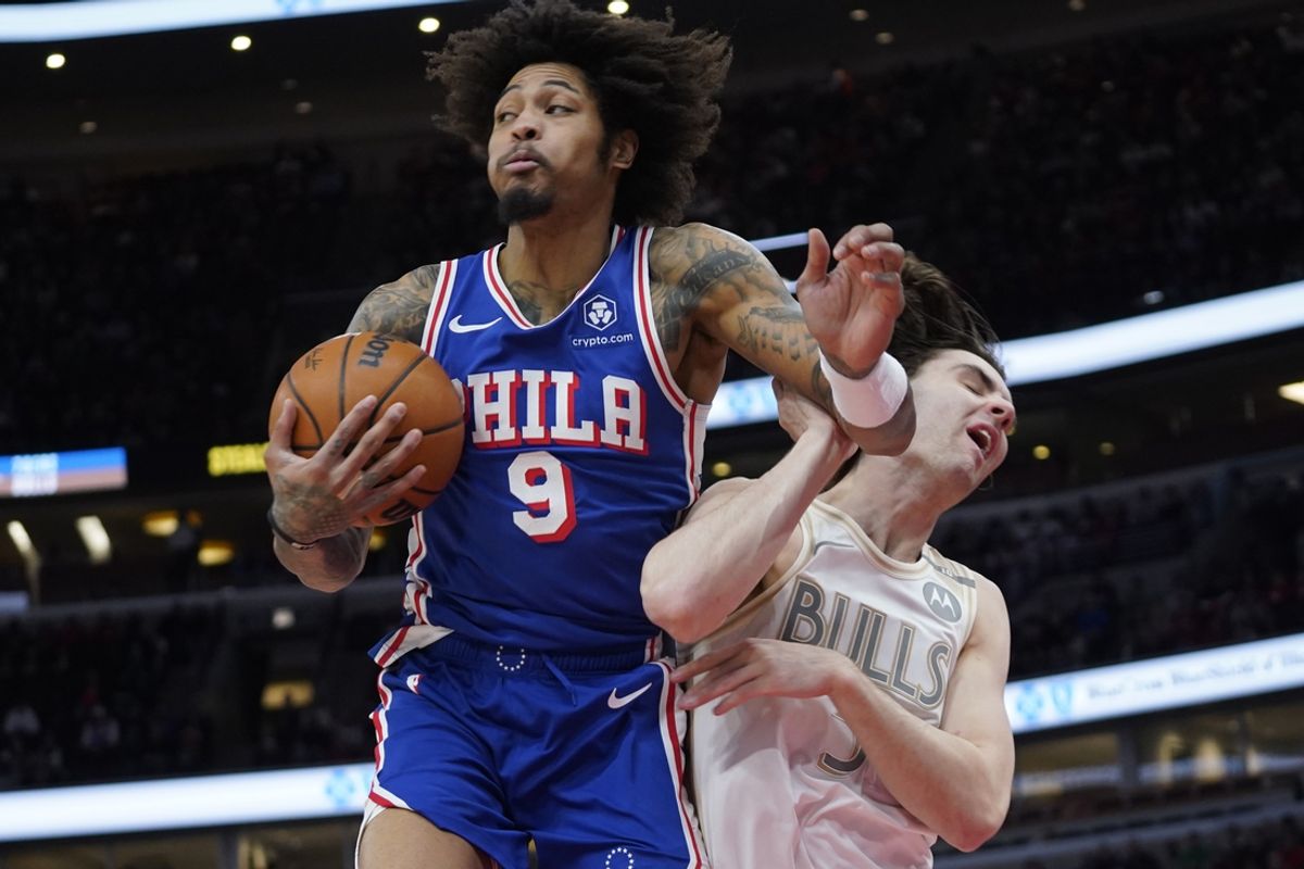 Jan 25, 2025; Chicago, Illinois, USA; Philadelphia 76ers guard Kelly Oubre Jr. (9) and Chicago Bulls guard Josh Giddey (3) go for the ball during the first quarter at United Center. Mandatory Credit: David Banks-Imagn Images