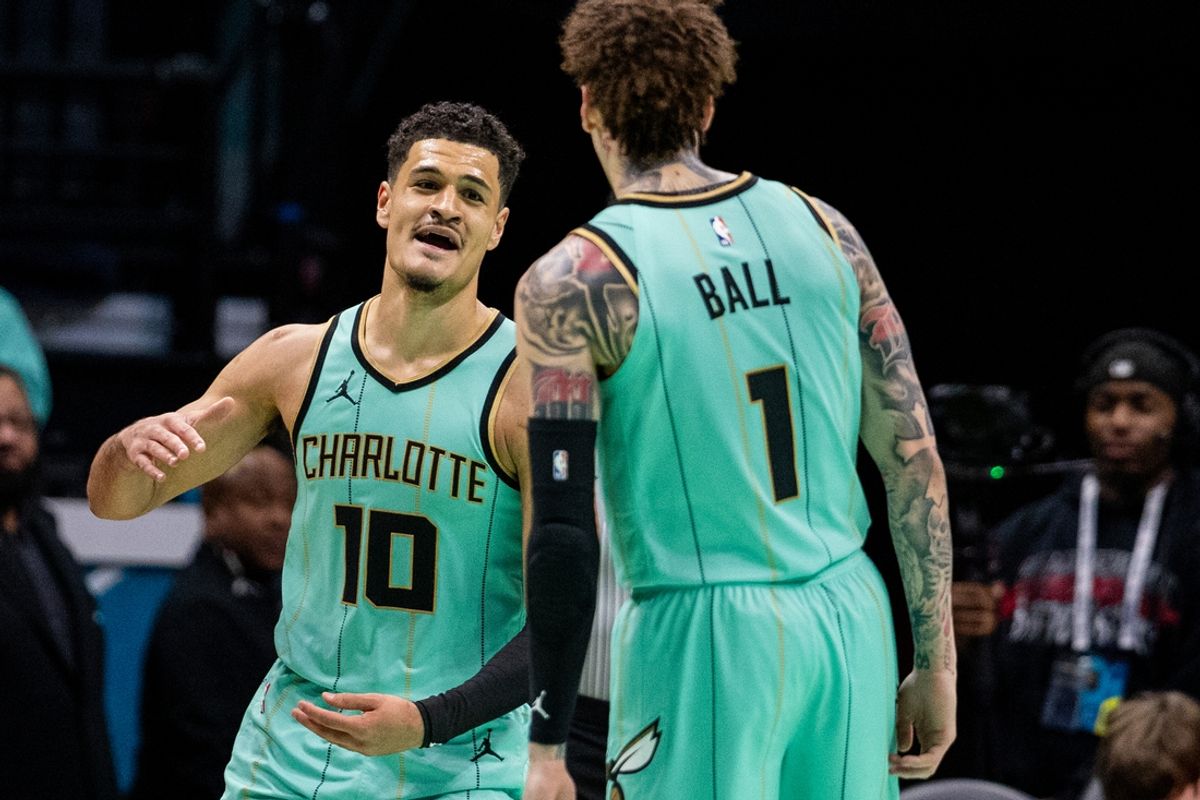 Jan 25, 2025; Charlotte, North Carolina, USA; Charlotte Hornets guard Josh Green (10) celebrates with guard LaMelo Ball (1) during the fourth quarter against the New Orleans Pelicans at Spectrum Center. Mandatory Credit: Scott Kinser-Imagn Images