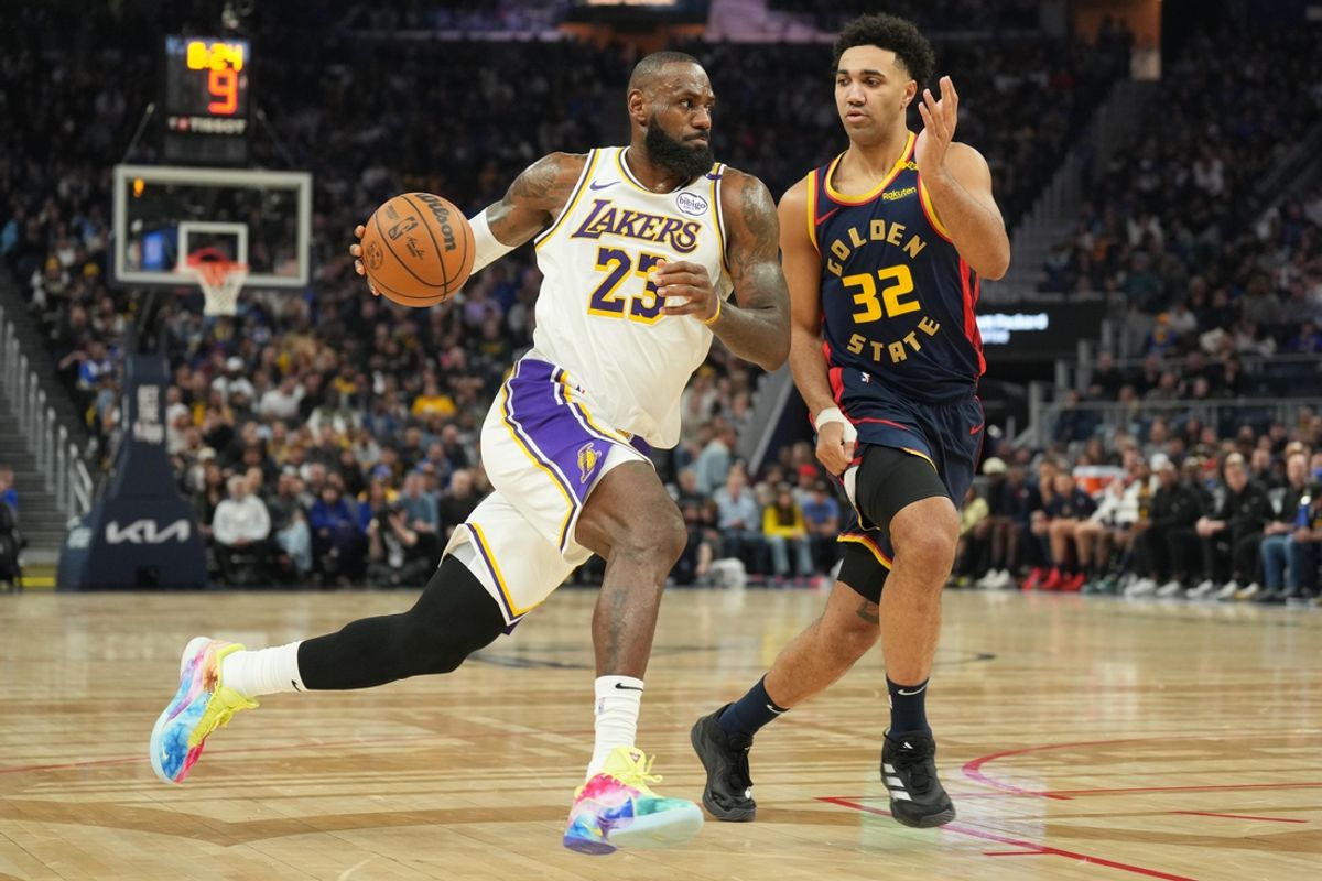 Jan 25, 2025; San Francisco, California, USA; Los Angeles Lakers forward LeBron James (23) dribbles against Golden State Warriors forward Trayce Jackson-Davis (32) during the second quarter at Chase Center. Mandatory Credit: Darren Yamashita-Imagn Images