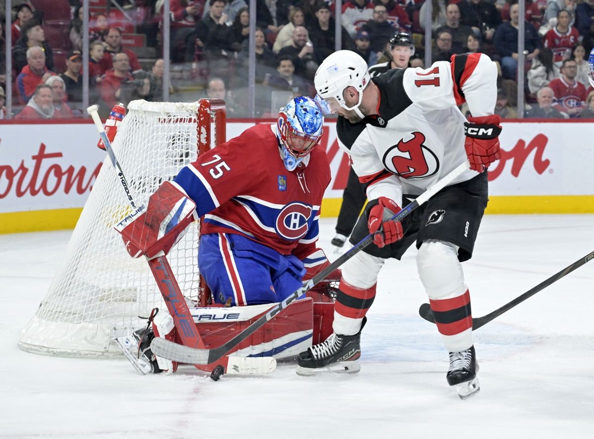 Jan 25, 2025; Montreal, Quebec, CAN; Montreal Canadiens goalie Jakub Dobes (75) stops New Jersey Devils forward Stefan Noesen (11) during the third period at the Bell Centre. Mandatory Credit: Eric Bolte-Imagn Images