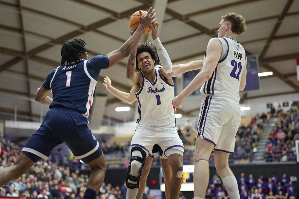 Jan 25, 2025; Portland, Oregon, USA; Portland Pilots center Jermaine Ballisager Webb (1) battles for a rebound during the first half against Gonzaga Bulldogs guard Michael Ajayi (1) at Chiles Center. Mandatory Credit: Troy Wayrynen-Imagn Images