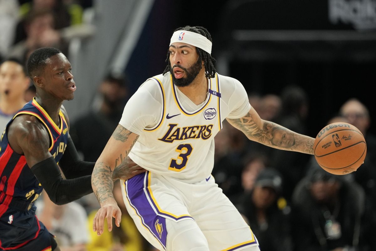 Jan 25, 2025; San Francisco, California, USA; Los Angeles Lakers forward Anthony Davis (3) dribbles against Golden State Warriors guard Dennis Schroder (left) during the fourth quarter at Chase Center. Mandatory Credit: Darren Yamashita-Imagn Images