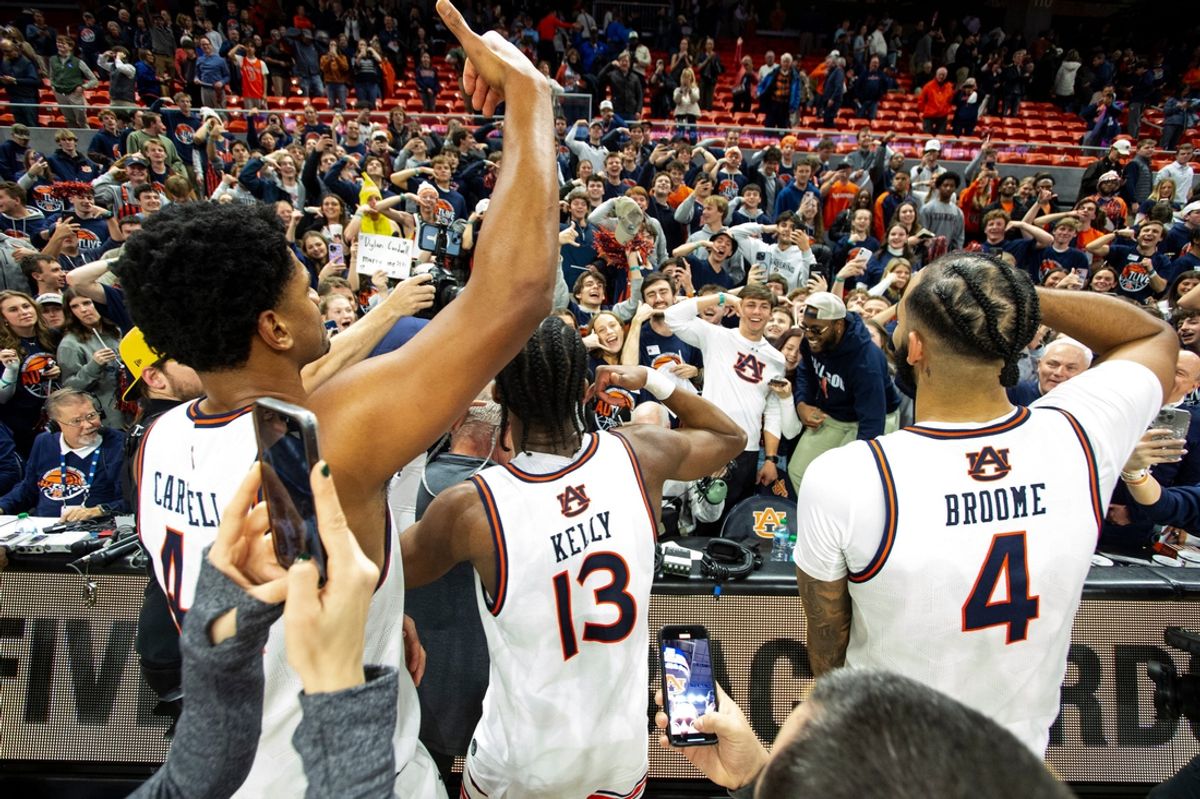 Auburn Tigers center Dylan Cardwell (44), guard Miles Kelly (13) and forward Johni Broome (4) celebrate as Auburn Tigers take on Tennessee Volunteers at Neville Arena in Auburn, Ala., on Saturday, Jan. 25, 2025. Auburn Tigers defeated Tennessee Volunteers 53-51.