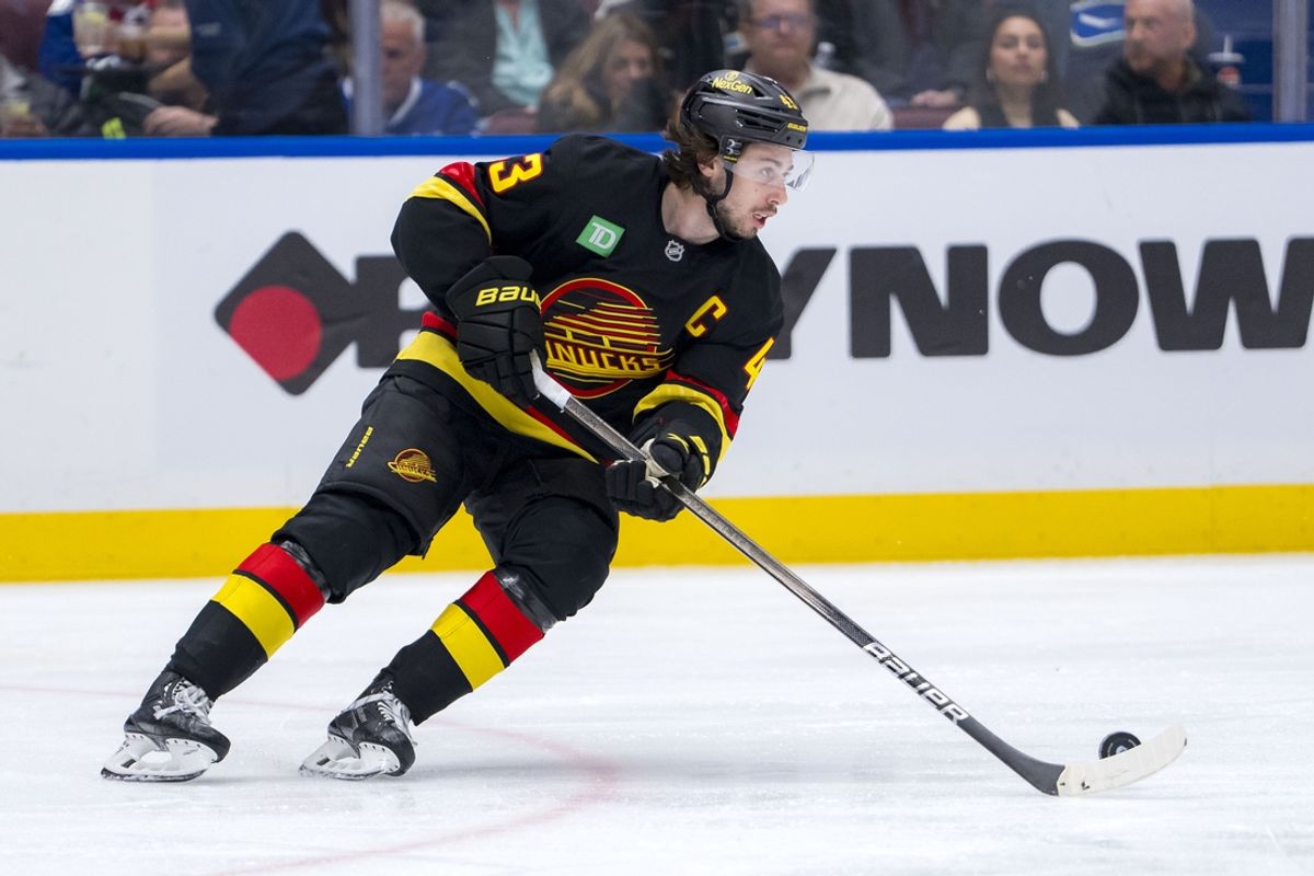 Jan 25, 2025; Vancouver, British Columbia, CAN; Vancouver Canucks defenseman Quinn Hughes (43) handles the puck against the Washington Capitals in the third period at Rogers Arena. Mandatory Credit: Bob Frid-Imagn Images