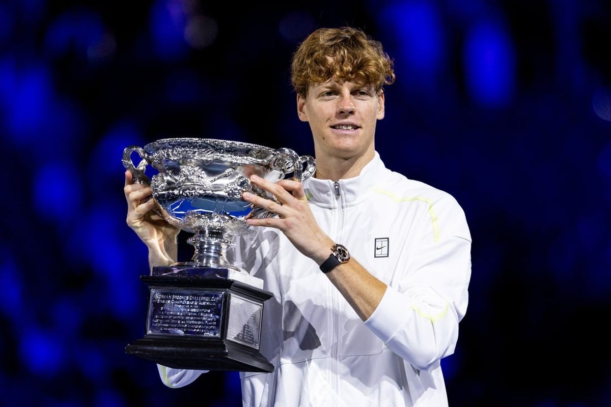 Jan 26, 2025; Melbourne, Victoria, Australia; Jannik Sinner of Italy celebrates with the Australian Open title during the prize presentation of the men's single at the 2025 Australian Open at Melbourne Park. Mandatory Credit: Mike Frey-Imagn Images