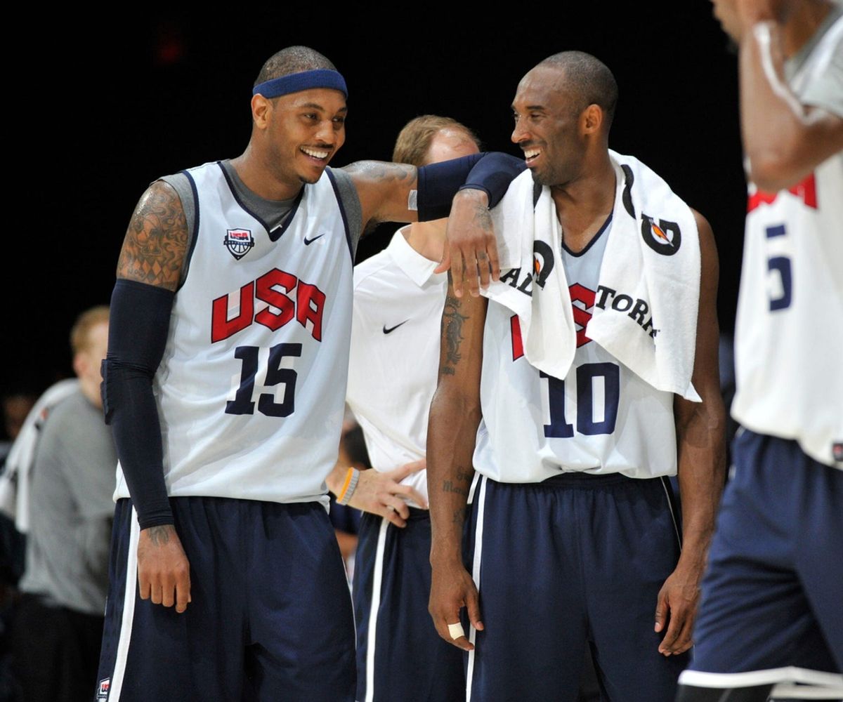 File photo: Former Team USA teammates Carmelo Anthony (15) and Kobe Bryant share a light moment following practice session for USA men's basketball team in Washington, DC.
