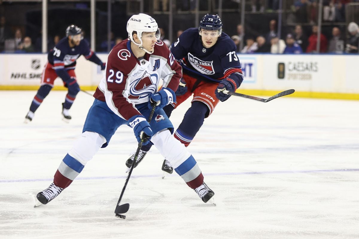Jan 26, 2025; New York, New York, USA;  Colorado Avalanche center Nathan MacKinnon (29) and New York Rangers center Matt Rempe (73) battle for control of the puck in the third period at Madison Square Garden. Mandatory Credit: Wendell Cruz-Imagn Images