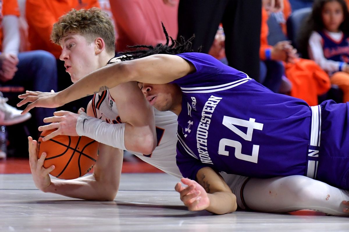 Jan 26, 2025; Champaign, Illinois, USA;  Illinois Fighting Illini guard Kasparas Jakucionis (32) and Northwestern Wildcats guard K.J. Windham (24) vie for a loose ball on the floor during the first half at State Farm Center. Mandatory Credit: Ron Johnson-Imagn Images