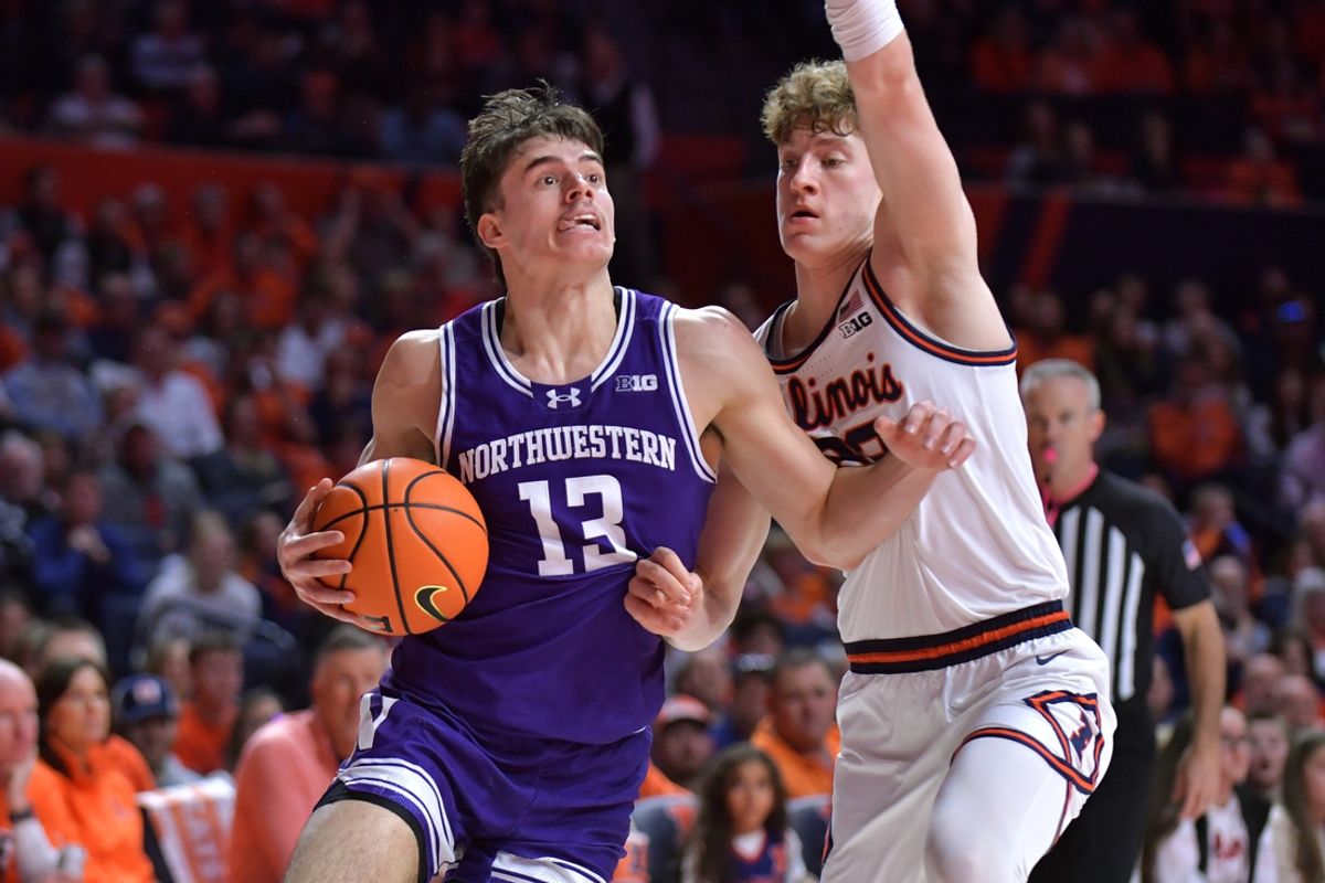Jan 26, 2025; Champaign, Illinois, USA;  Northwestern Wildcats guard Brooks Barnhizer (13) drives the ball against Illinois Fighting Illini guard Kasparas Jakucionis (32) during the second half at State Farm Center. Mandatory Credit: Ron Johnson-Imagn Images