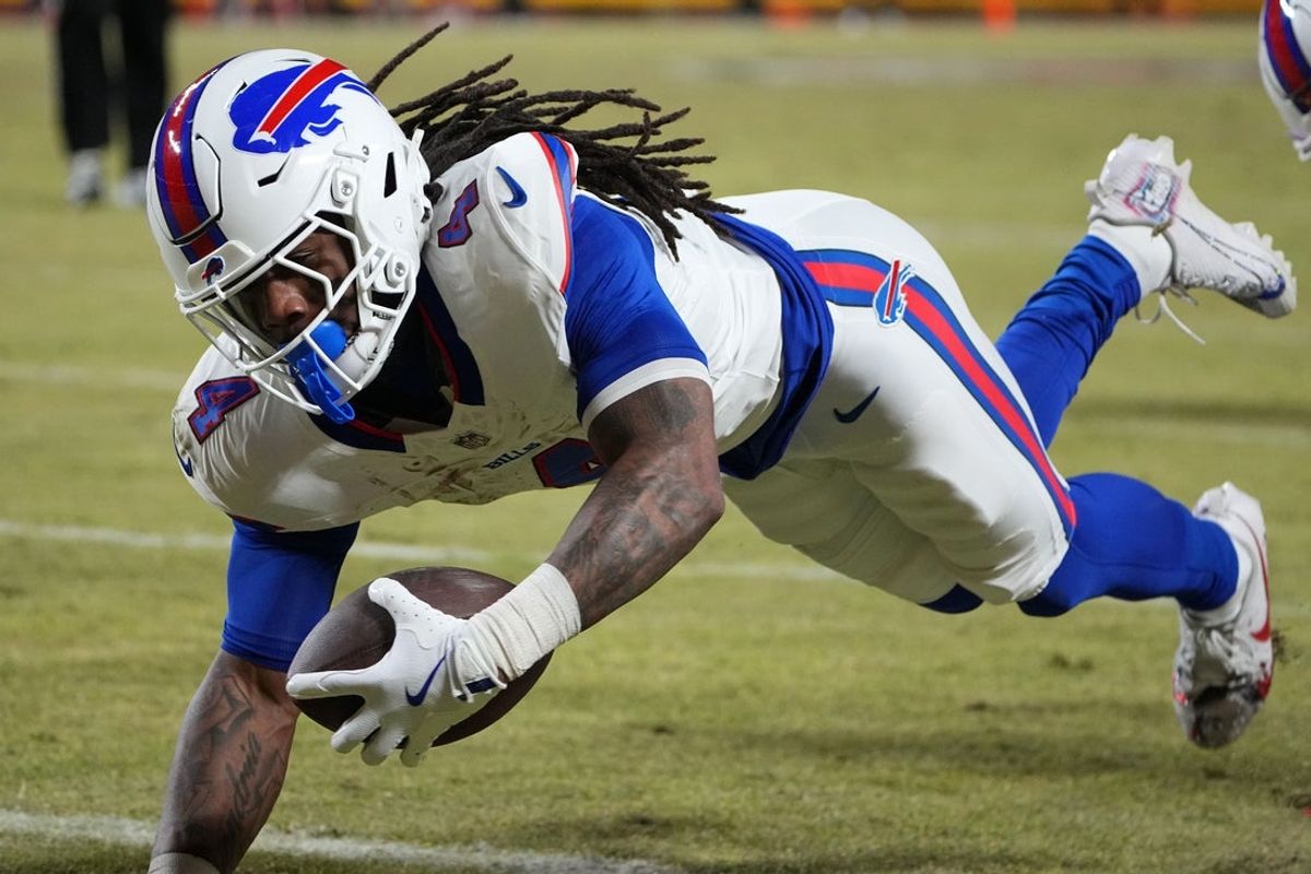 Jan 26, 2025; Kansas City, MO, USA; Buffalo Bills running back James Cook (4) dives for a touchdown against the Kansas City Chiefs in the AFC Championship game at GEHA Field at Arrowhead Stadium. Mandatory Credit: Denny Medley-Imagn Images