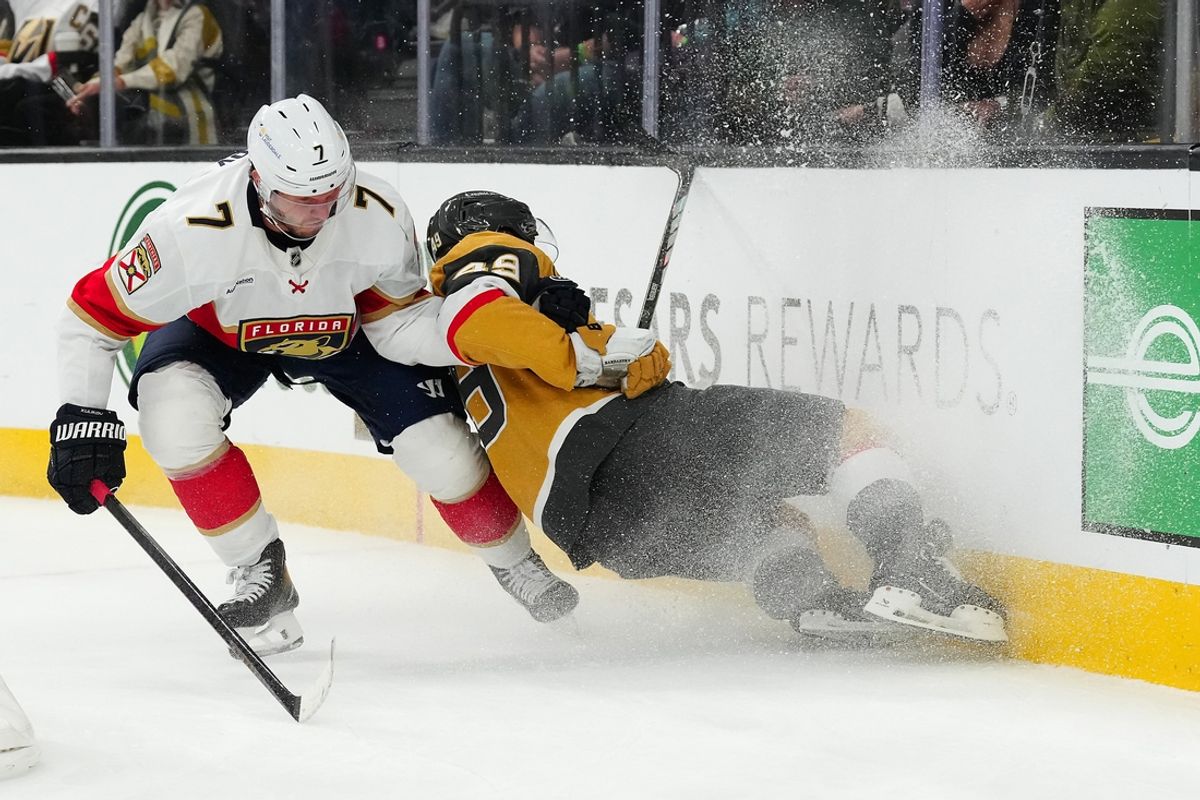 Jan 26, 2025; Las Vegas, Nevada, USA; Florida Panthers defenseman Dmitry Kulikov (7) checks Vegas Golden Knights center Ivan Barbashev (49) into the boards during the second period at T-Mobile Arena. Mandatory Credit: Stephen R. Sylvanie-Imagn Images