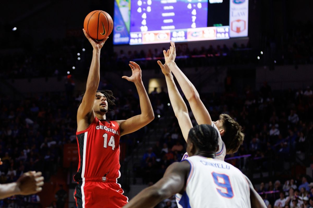 Jan 25, 2025; Gainesville, Florida, USA; Georgia Bulldogs forward Asa Newell (14) shoots over Florida Gators forward Alex Condon (21) during the first half at Exactech Arena at the Stephen C. O'Connell Center. Mandatory Credit: Matt Pendleton-Imagn Images