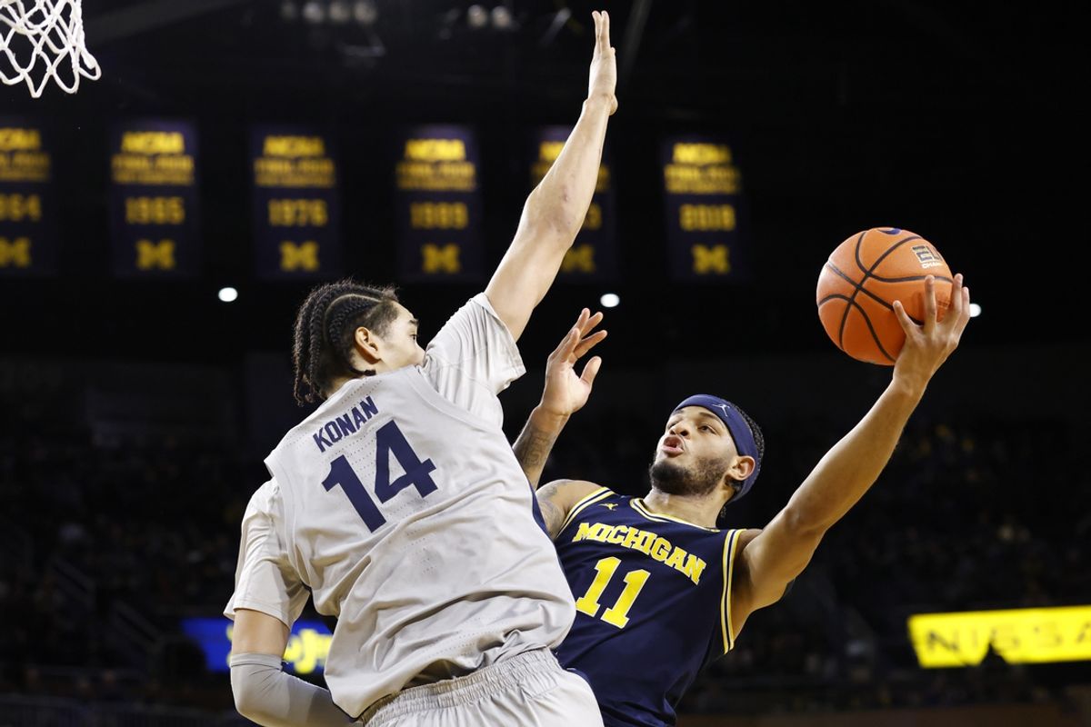 Jan 27, 2025; Ann Arbor, Michigan, USA;  Michigan Wolverines guard Roddy Gayle Jr. (11) shoots against Penn State Nittany Lions forward Yanic Konan Niederhauser (14) in the first half at Crisler Center. Mandatory Credit: Rick Osentoski-Imagn Images