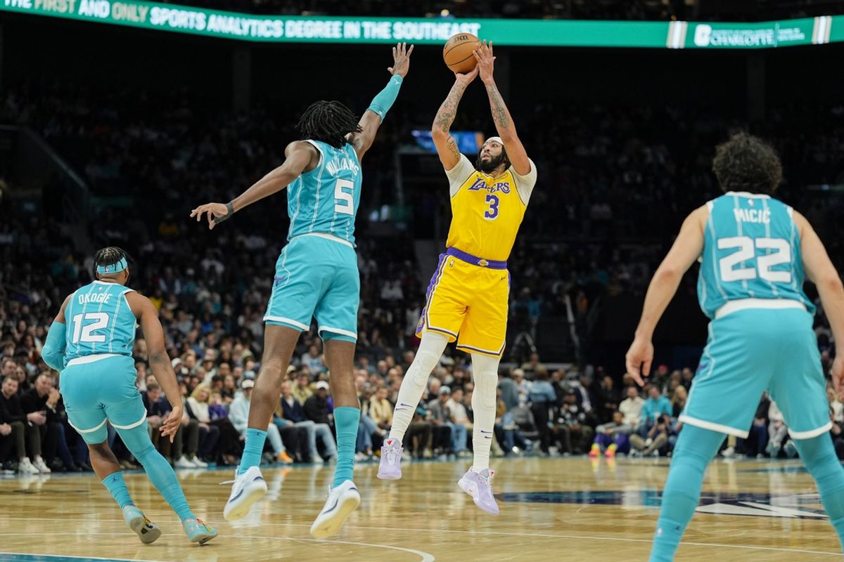 Jan 27, 2025; Charlotte, North Carolina, USA; Los Angeles Lakers forward Anthony Davis (3) shoots a three pointer over Charlotte Hornets center Mark Williams (5) during the first quarter at the Spectrum Center. Mandatory Credit: Jim Dedmon-Imagn Images