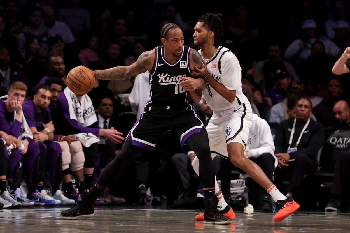 Jan 27, 2025; Brooklyn, New York, USA; Sacramento Kings forward DeMar DeRozan (10) controls the ball against Brooklyn Nets forward Ziaire Williams (8) during the second quarter at Barclays Center. Mandatory Credit: Brad Penner-Imagn Images