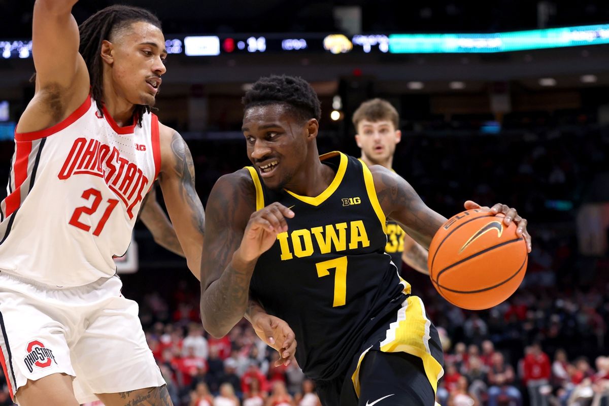 Jan 27, 2025; Columbus, Ohio, USA; Iowa Hawkeyes forward Seydou Traore (7) drives to the basket as Ohio State Buckeyes forward Devin Royal (21) defends during the first half at Value City Arena. Mandatory Credit: Joseph Maiorana-Imagn Images