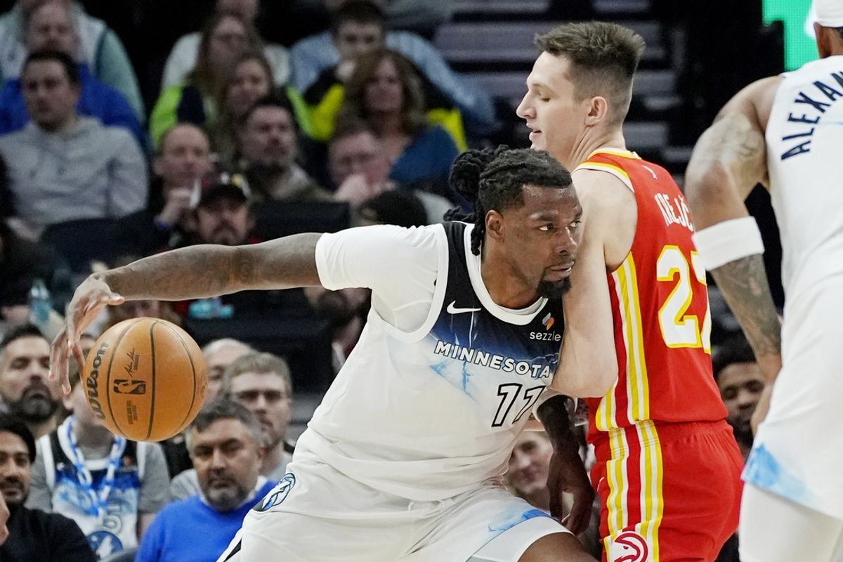 Jan 27, 2025; Minneapolis, Minnesota, USA; Minnesota Timberwolves center Naz Reid (11) dribbles against Atlanta Hawks forward Vit Krejci (27) at Target Center. Mandatory Credit: Bruce Kluckhohn-Imagn Images