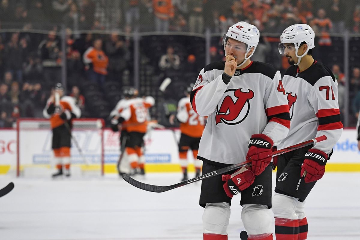 Jan 27, 2025; Philadelphia, Pennsylvania, USA; New Jersey Devils center Curtis Lazar (42) and New Jersey Devils defenseman Jonas Siegenthaler (71) skate off the ice after loss to the Philadelphia Flyers at Wells Fargo Center. Mandatory Credit: Eric Hartline-Imagn Images