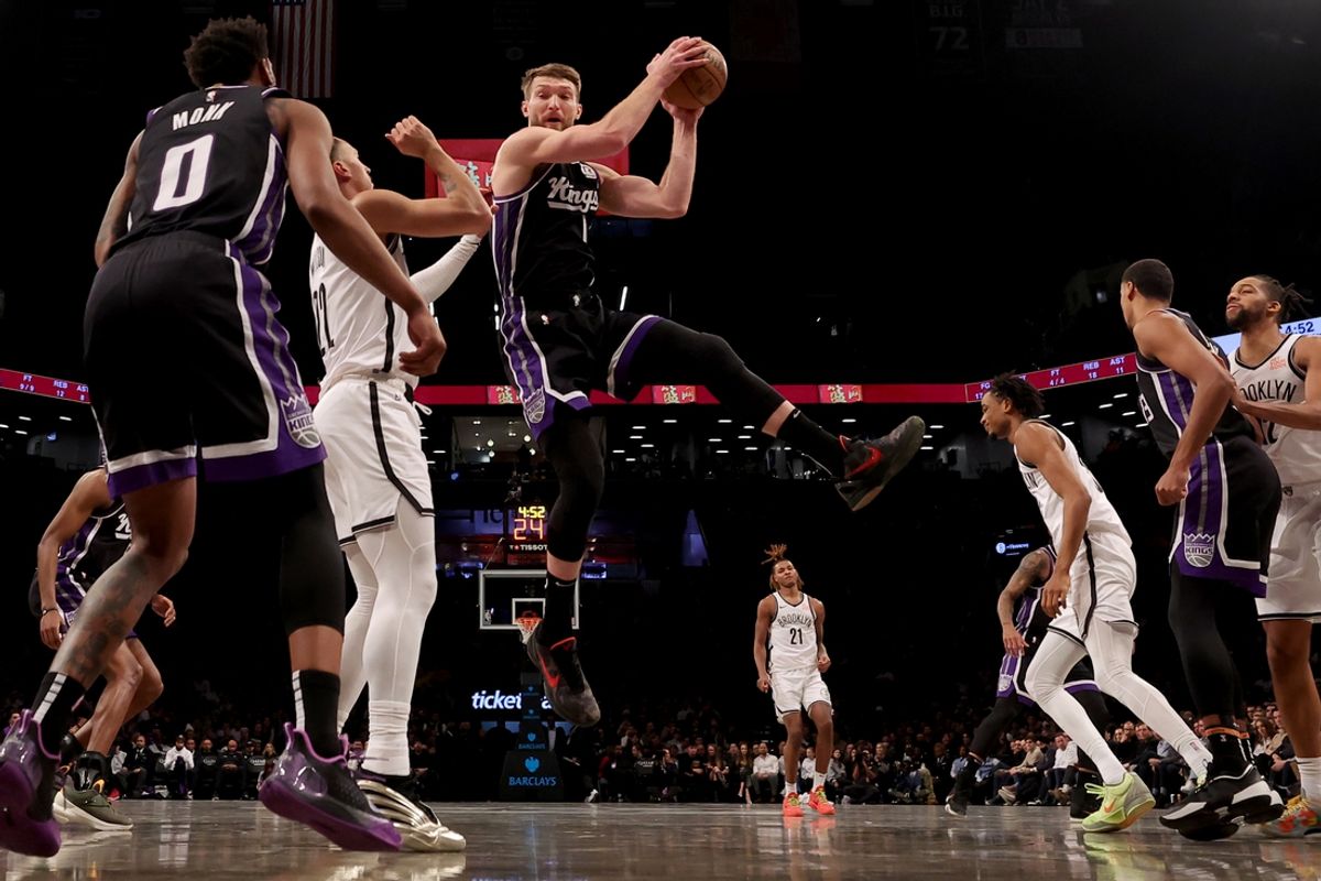 Jan 27, 2025; Brooklyn, New York, USA; Sacramento Kings forward Domantas Sabonis (11) grabs a rebound against Brooklyn Nets forward Jalen Wilson (22) during the second quarter at Barclays Center. Mandatory Credit: Brad Penner-Imagn Images