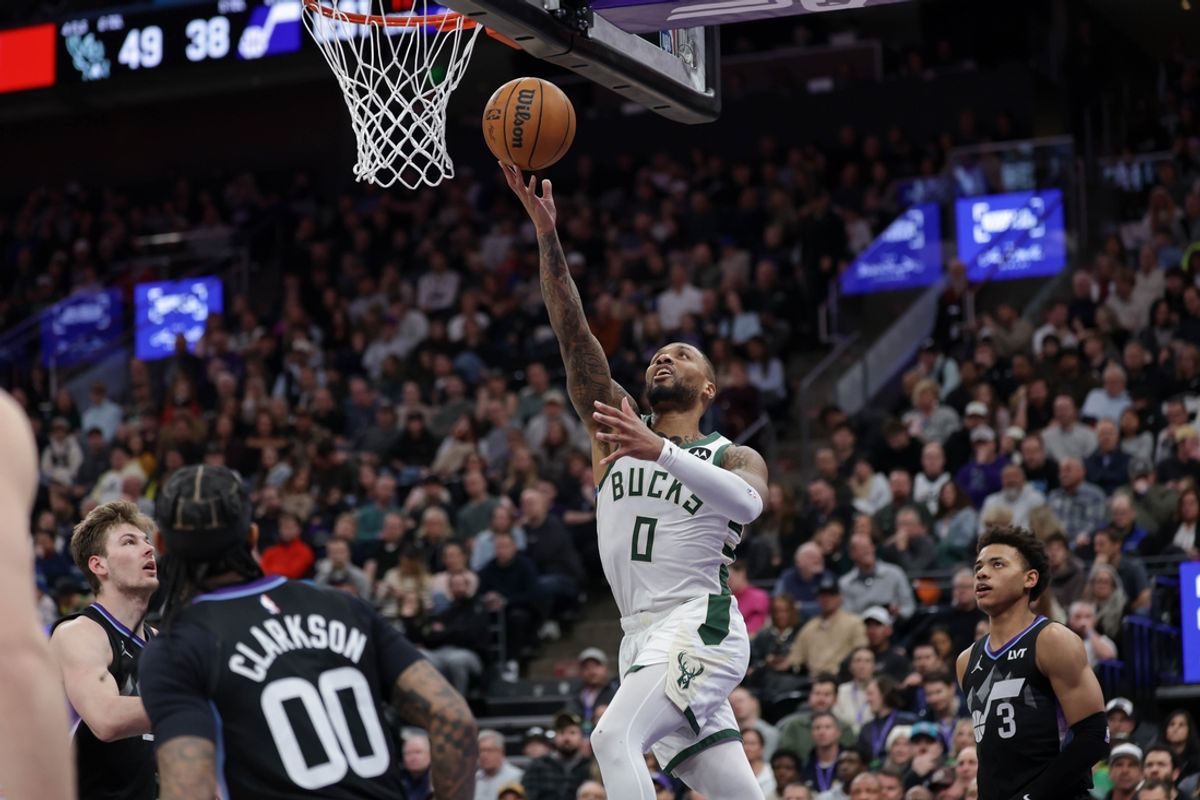 Jan 27, 2025; Salt Lake City, Utah, USA;  Milwaukee Bucks guard Damian Lillard (0) lays the ball up to the basket during the second quarter against the Utah Jazz at Delta Center. Mandatory Credit: Chris Nicoll-Imagn Images