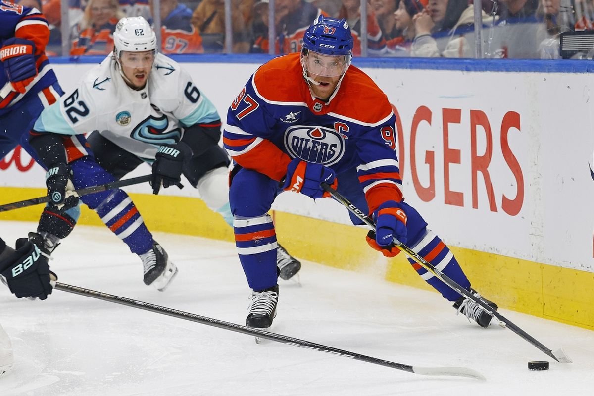 Jan 27, 2025; Edmonton, Alberta, CAN; Edmonton Oilers forward Connor McDavid (97) looks to pass in front of Seattle Kraken defensemen Brandon Montour (62) during the first period at Rogers Place. Mandatory Credit: Perry Nelson-Imagn Images