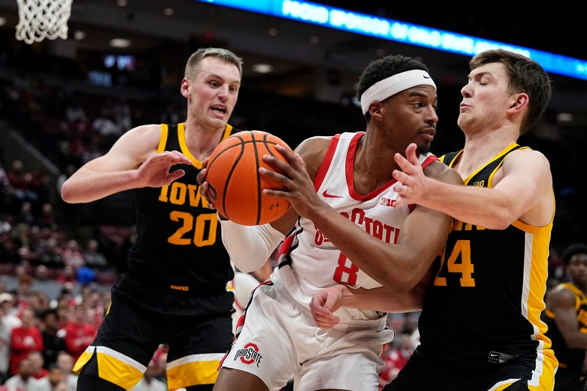 Ohio State Buckeyes guard Micah Parrish (8) looks to pass over Iowa Hawkeyes forward Pryce Sandfort (24) during the second half of the NCAA men's basketball game at Value City Arena on Jan. 27, 2025. Ohio State won 82-65.