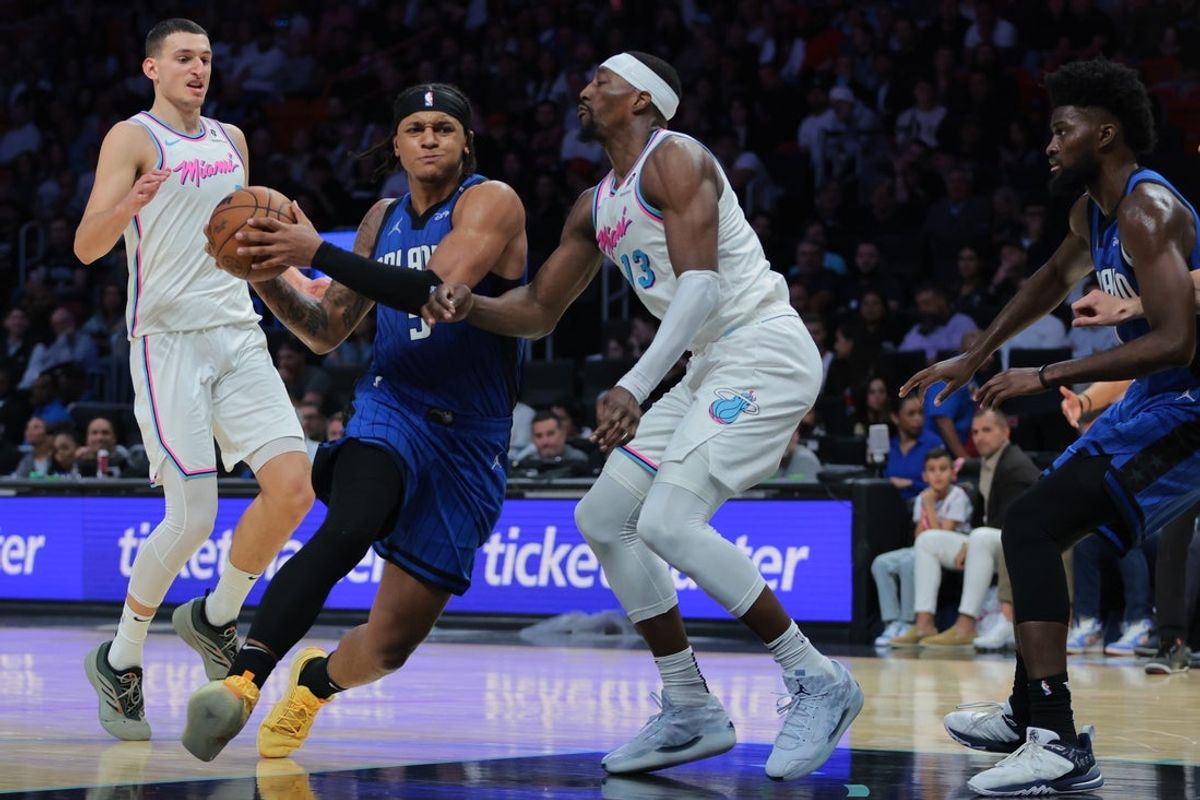 Jan 27, 2025; Miami, Florida, USA; Orlando Magic forward Paolo Banchero (5) drives to the basket against Miami Heat center Bam Adebayo (13) during the fourth quarter at Kaseya Center. Mandatory Credit: Sam Navarro-Imagn Images