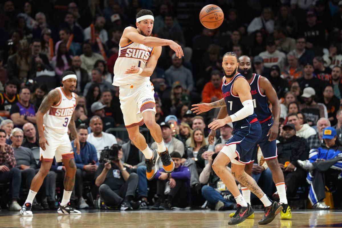 Jan 27, 2025; Phoenix, Arizona, USA; Phoenix Suns guard Devin Booker (1) passes against the LA Clippers during the second half at Footprint Center. Mandatory Credit: Joe Camporeale-Imagn Images