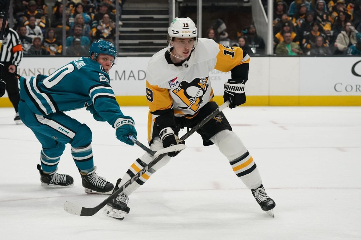 Jan 27, 2025; San Jose, California, USA;  Pittsburgh Penguins center Cody Glass (19) waits for the puck while defended by San Jose Sharks left wing Fabian Zetterlund (20) in the third period at SAP Center at San Jose. Mandatory Credit: David Gonzales-Imagn Images