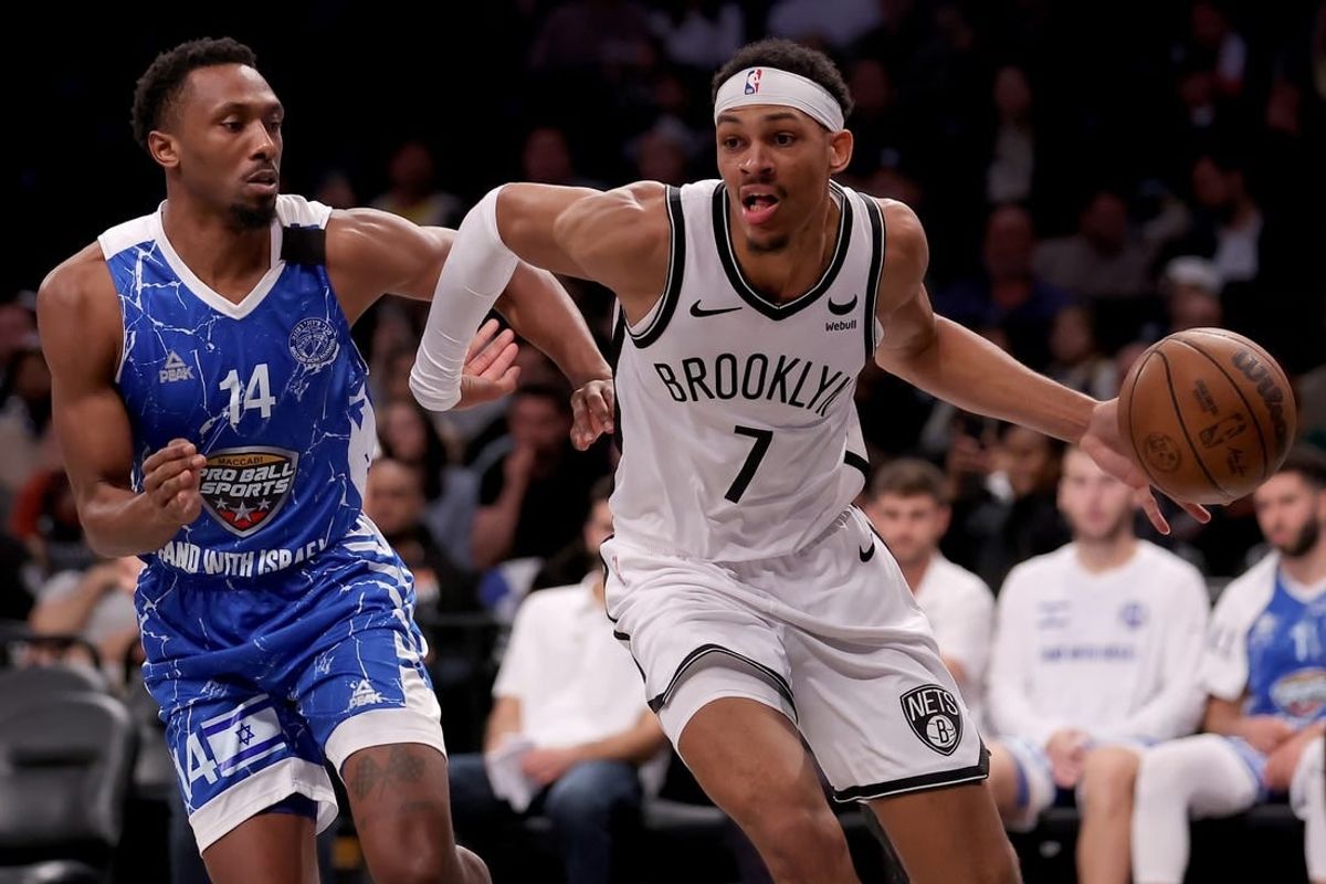 Oct 12, 2023; Brooklyn, NY, USA; Brooklyn Nets forward Darius Bazley (7) drives to the basket against Maccabi Ra'anana guard Dakarai Tucker (14) during the fourth quarter at Barclays Center.