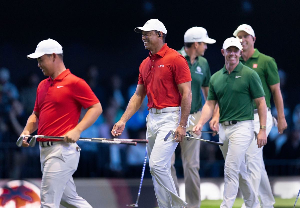 Tiger Woods, center, and Tom Kim, left, of Jupiter Links GC enjoy their match against Keegan Bradley, Rory McIlroy and Adam Scott of Boston Common during a TGL match against Boston Common at the SoFi Center on January 27, 2025, in Palm Beach Gardens, Florida.