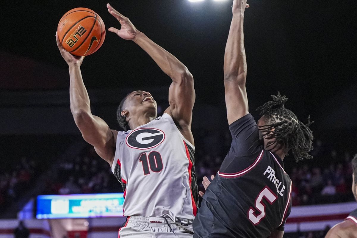 Jan 28, 2025; Athens, Georgia, USA; Georgia Bulldogs forward RJ Godfrey (10) shoots over South Carolina Gamecocks forward Nick Pringle (5) during the first half at Stegeman Coliseum. Mandatory Credit: Dale Zanine-Imagn Images