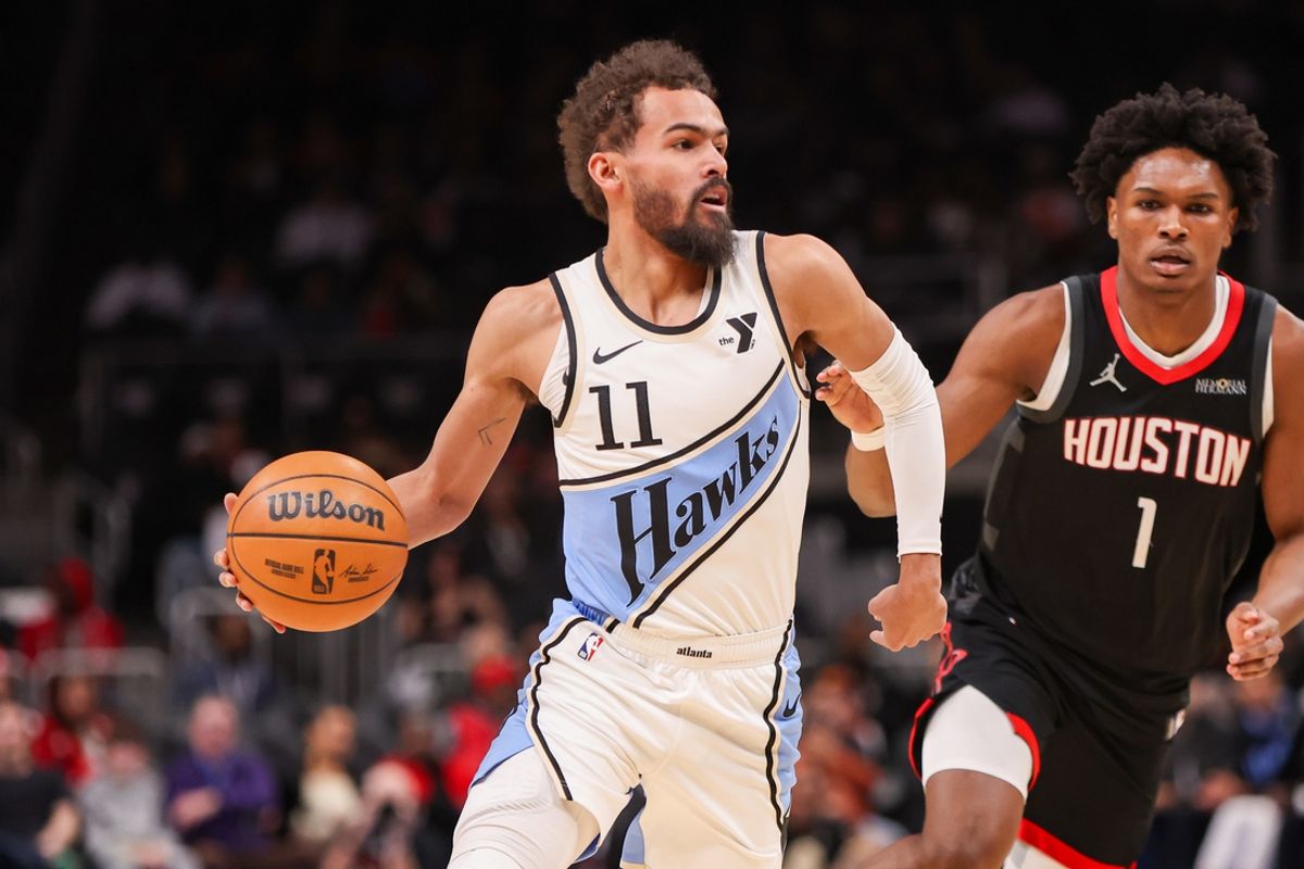 Jan 28, 2025; Atlanta, Georgia, USA; Atlanta Hawks guard Trae Young (11) is defended by Houston Rockets forward Amen Thompson (1) in the first quarter at State Farm Arena. Mandatory Credit: Brett Davis-Imagn Images
