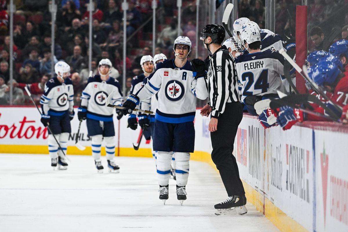 Jan 28, 2025; Montreal, Quebec, CAN; Winnipeg Jets center Mark Scheifele (55) celebrates with his teammates at the bench his goal against the Montreal Canadiens during the second period at Bell Centre. Mandatory Credit: David Kirouac-Imagn Images