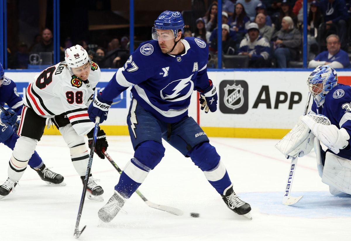 Jan 28, 2025; Tampa, Florida, USA; Chicago Blackhawks center Connor Bedard (98) shoots asTampa Bay Lightning defenseman Ryan McDonagh (27) defends during the second period at Amalie Arena. Mandatory Credit: Kim Klement Neitzel-Imagn Images