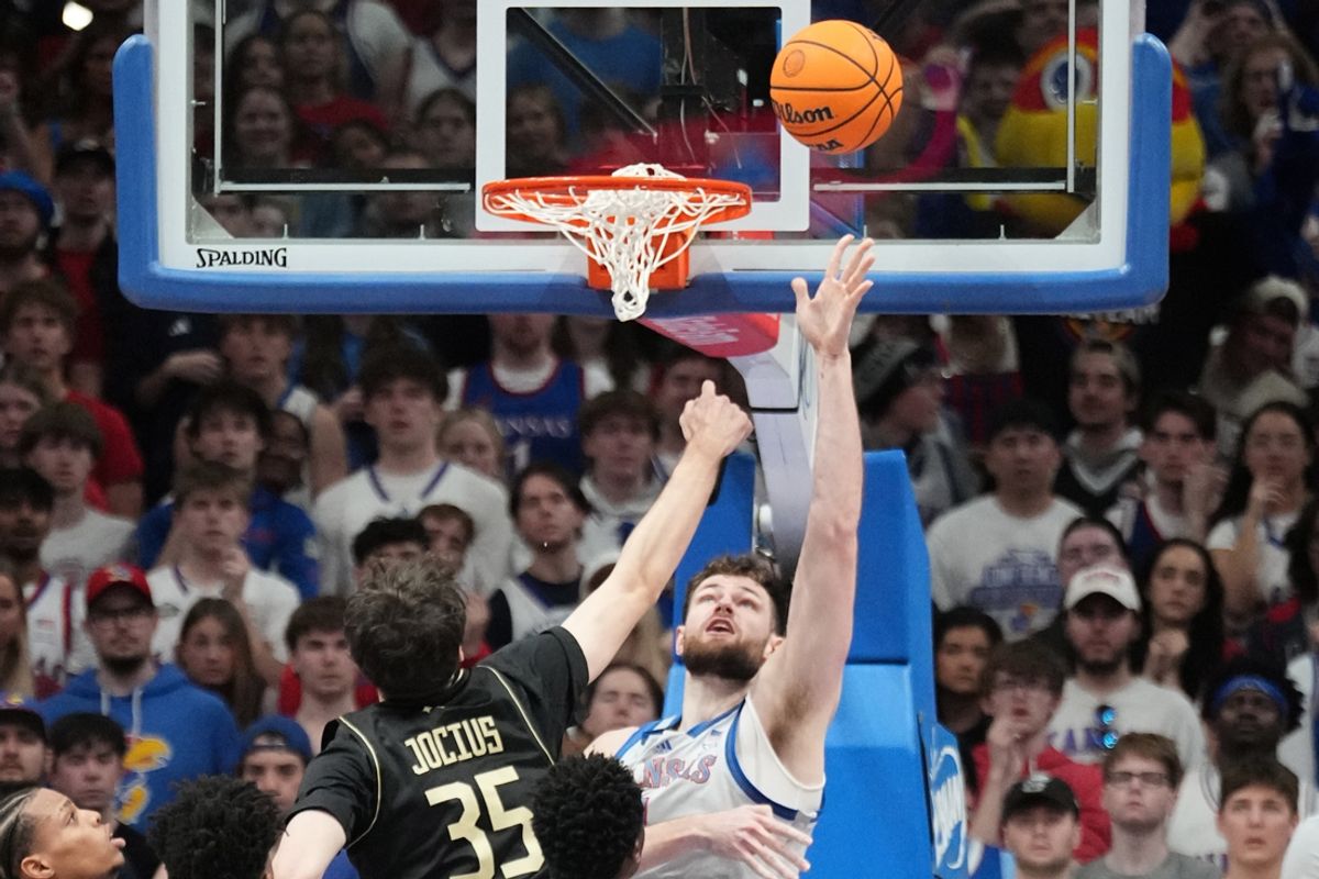 Jan 28, 2025; Lawrence, Kansas, USA; Kansas Jayhawks center Hunter Dickinson (1) shoots as UCF Knights forward Rokas Jocius (35) defends during the first half at Allen Fieldhouse. Mandatory Credit: Denny Medley-Imagn Images