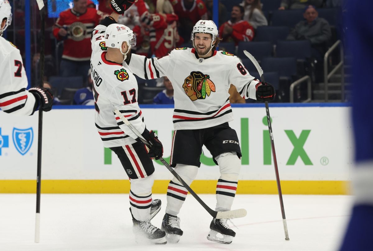 Jan 28, 2025; Tampa, Florida, USA; Chicago Blackhawks left wing Landon Slaggert (84) celebrates with left wing Nick Foligno (17) after he scored a goal against the Tampa Bay Lightning during the second period at Amalie Arena. Mandatory Credit: Kim Klement Neitzel-Imagn Images