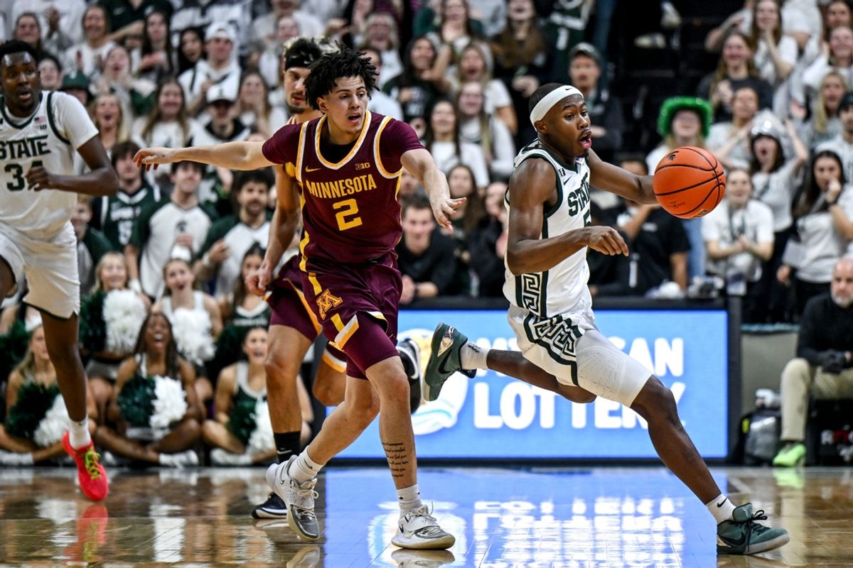 Michigan State's Tre Holloman, right, steals the ball from Minnesota's Mike Mitchell Jr. during the first half on Tuesday, Jan. 28, 2025, at the Breslin Center in East Lansing.