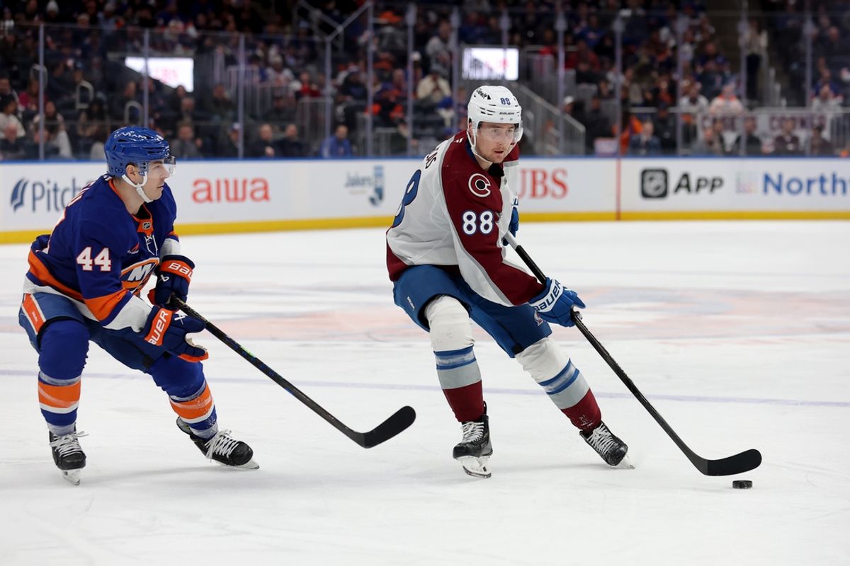 Jan 28, 2025; Elmont, New York, USA; Colorado Avalanche center Martin Necas (88) skates with the puck against New York Islanders center Jean-Gabriel Pageau (44) during the third period at UBS Arena. Mandatory Credit: Brad Penner-Imagn Images