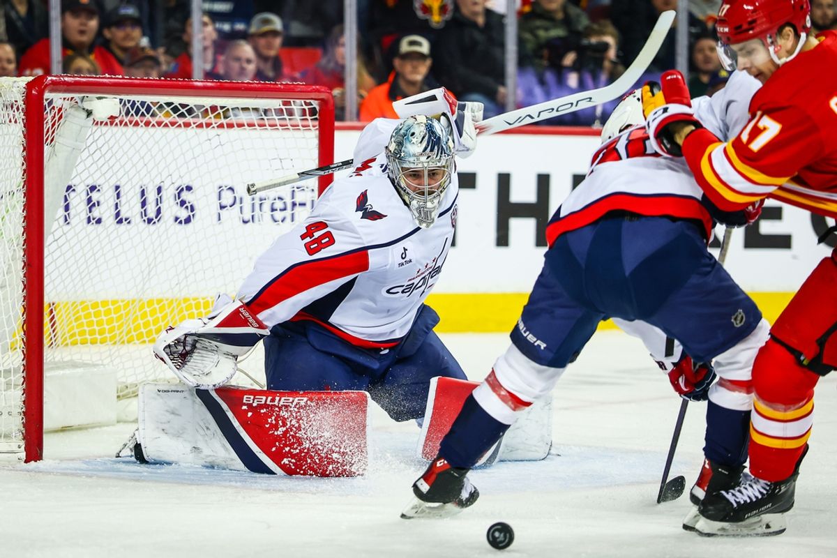 Jan 28, 2025; Calgary, Alberta, CAN; Washington Capitals goaltender Logan Thompson (48) makes a save against the Calgary Flames during the second period at Scotiabank Saddledome. Mandatory Credit: Sergei Belski-Imagn Images