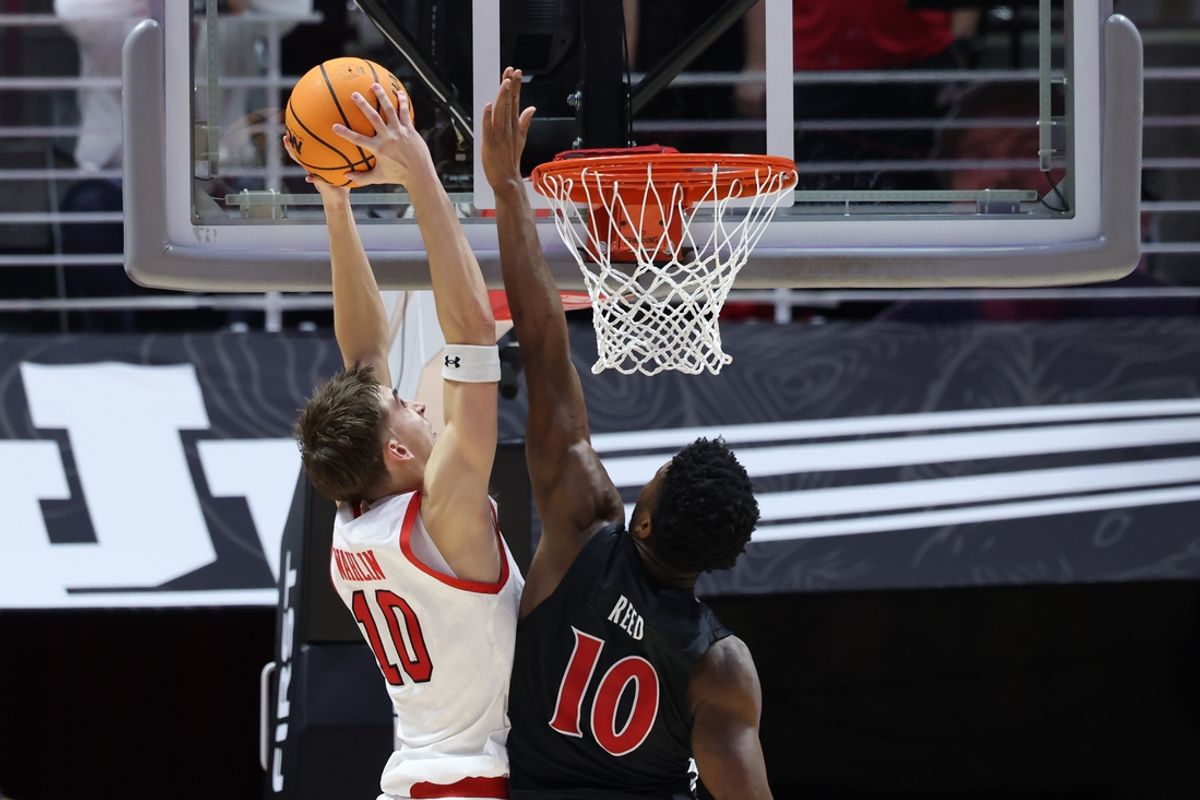Jan 28, 2025; Salt Lake City, Utah, USA; Utah Utes forward Jake Wahlin (10) goes to the basket against Cincinnati Bearcats guard Josh Reed (10) during the first half at Jon M. Huntsman Center. Mandatory Credit: Rob Gray-Imagn Images