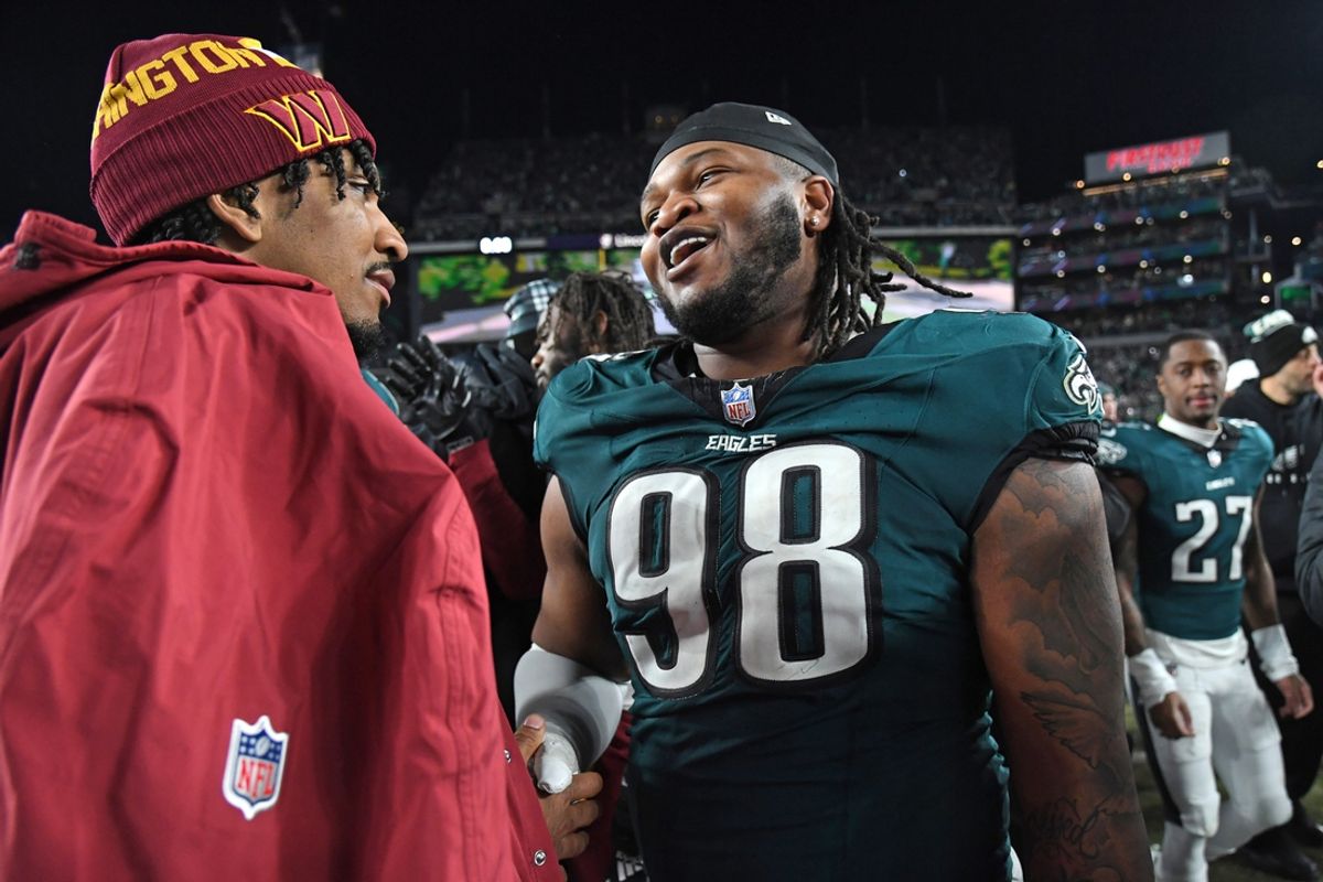 Jan 26, 2025; Philadelphia, PA, USA; Washington Commanders quarterback Jayden Daniels (5) and Philadelphia Eagles defensive tackle Jalen Carter (98) after the NFC Championship game at Lincoln Financial Field. Mandatory Credit: Eric Hartline-Imagn Images